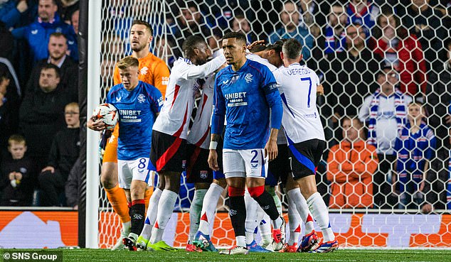 James Tavernier turns away in frustration as Lacazette is congratulated for his first goal at Ibrox.