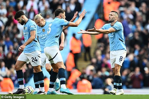 MANCHESTER, ENGLAND - OCTOBER 05: Mateo Kovacic of Manchester City celebrates scoring his team's first goal with teammate Ruben Dias during the Premier League match between Manchester City FC and Fulham FC at Etihad Stadium on October 05, 2024 in Manchester, England. (Photo by Gareth Copley/Getty Images)