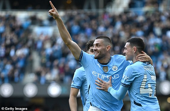 MANCHESTER, ENGLAND - OCTOBER 05: Mateo Kovacic of Manchester City celebrates scoring his team's second goal with teammate Phil Foden during the Premier League match between Manchester City FC and Fulham FC at Etihad Stadium on October 05, 2024 in Manchester, England. (Photo by Gareth Copley/Getty Images)