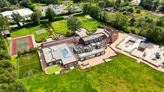 The building is U shaped with ample parking. The remainder of the grounds are laid to lawn with mature trees and a meadow.