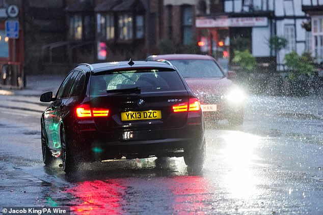 Rain falls as motorists travel through Warwick, after thundery showers on Monday brought big downpours