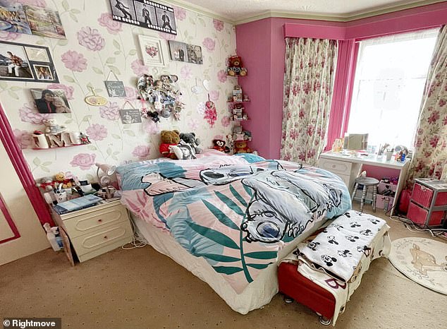 The bedroom of the four bedroom detached property in the coastal town of Bournemouth - with an Elvis pillow on the bed and pictures on the wall