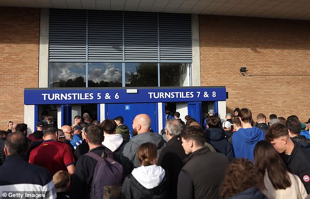 Fans pictured waiting outside of Portman Road, where kick-off needed to be pushed back