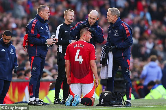 MANCHESTER, ENGLAND - OCTOBER 19: Matthijs de Ligt of Manchester United receives treatment off the pitch for a head injury during the Premier League match between Manchester United FC and Brentford FC at Old Trafford on October 19, 2024 in Manchester, England. (Photo by James Gill - Danehouse/Getty Images)