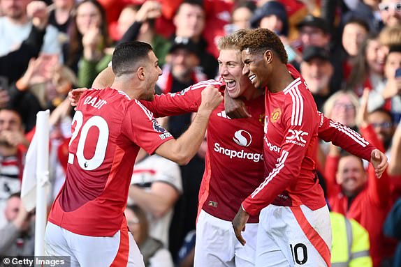 MANCHESTER, ENGLAND - OCTOBER 19: Rasmus Hojlund of Manchester United celebrates scoring his team's second goal with teammates Marcus Rashford and Diogo Dalot during the Premier League match between Manchester United FC and Brentford FC at Old Trafford on October 19, 2024 in Manchester, England. (Photo by Gareth Copley/Getty Images)