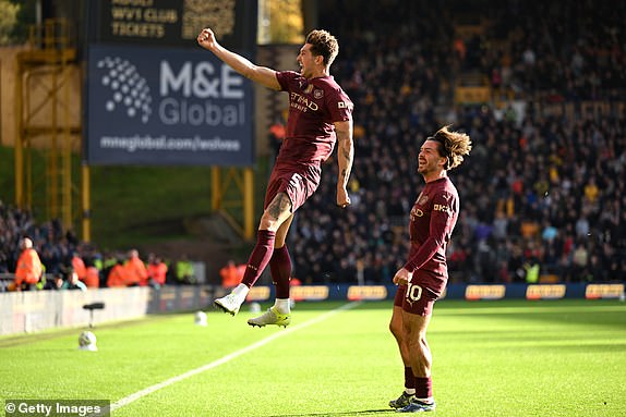 WOLVERHAMPTON, ENGLAND - OCTOBER 20: John Stones of Manchester City celebrates scoring his team's second goal during the Premier League match between Wolverhampton Wanderers FC and Manchester City FC at Molineux on October 20, 2024 in Wolverhampton, England. (Photo by Shaun Botterill/Getty Images)