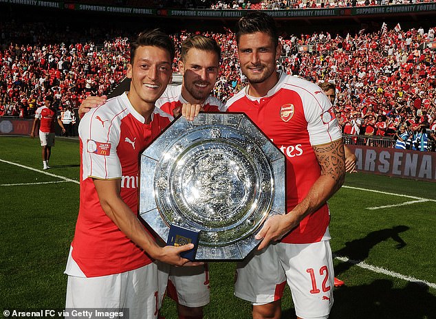 Ozil and Ramsey alongside striker Olivier Giroud (right) after winning the Community Shield