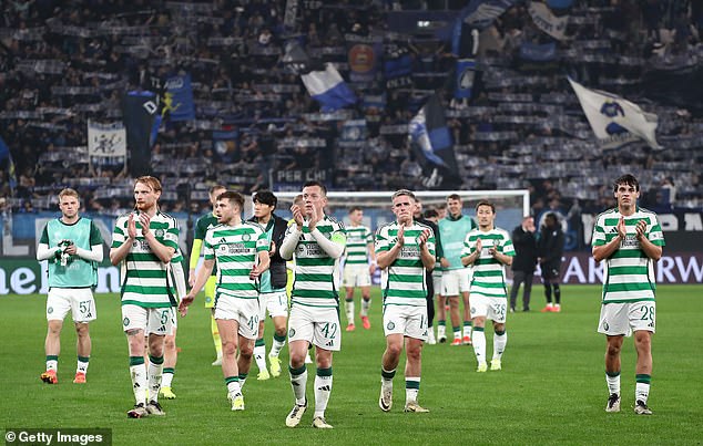 Celtic's players take the acclaim of the travelling support after a  courageous team performance