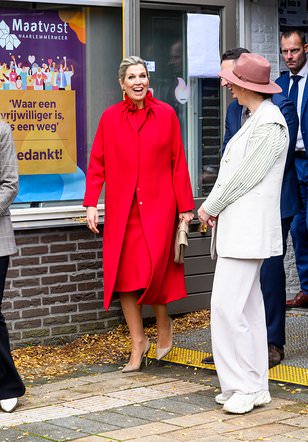 Queen Máxima of the Netherlands wows in a matching scarlet coat and dress as she packs her