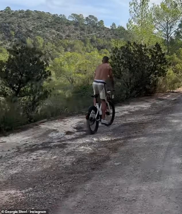 In a video from their trip, Georgia shared captured Harry cycling from behind