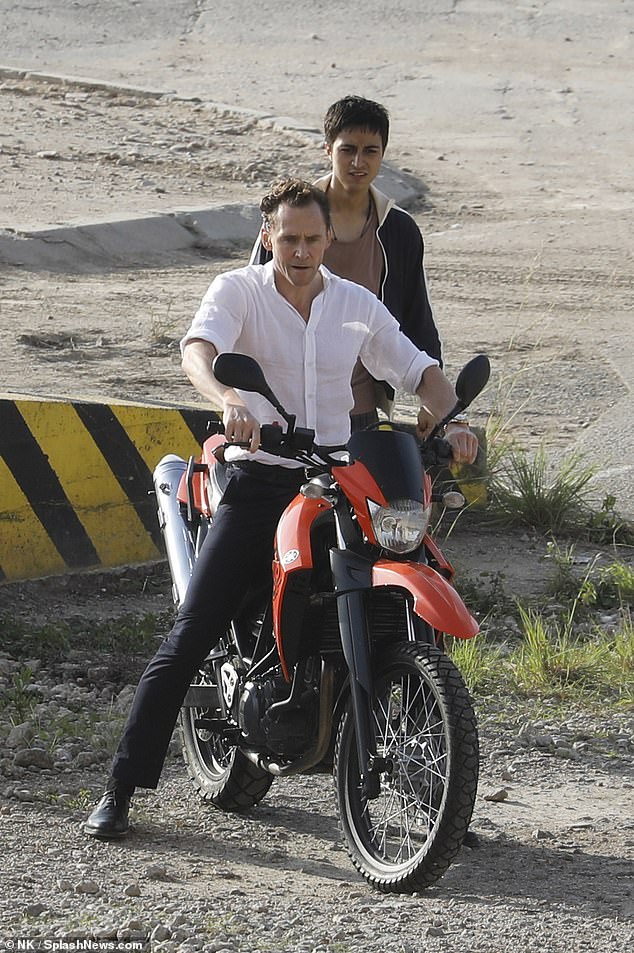 Tom Hiddleston prepares to do his own stunt on the back of a motorbike on the set of The Night Manager