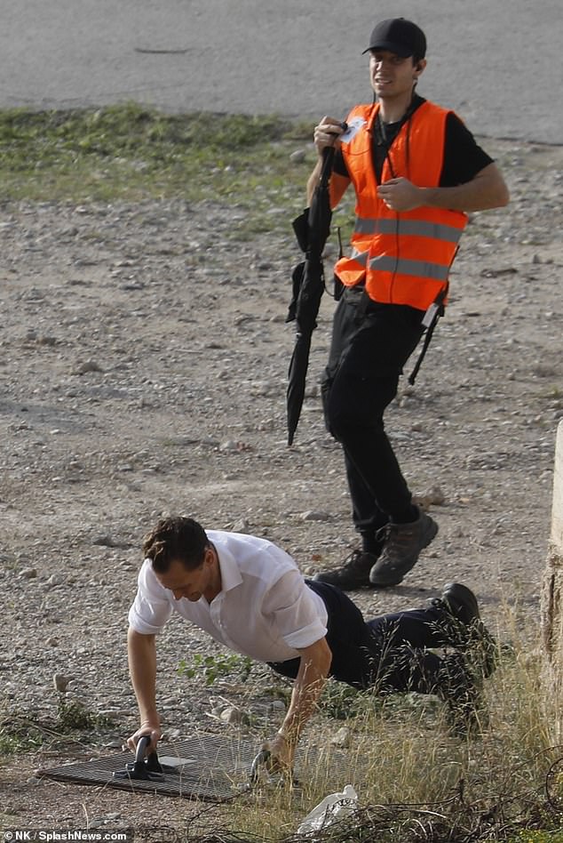 Tom Hiddleston takes some time to do some press ups as he appears on set of The Night Manager