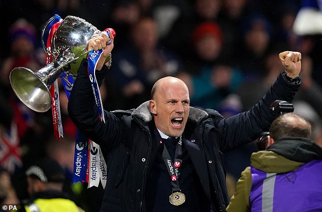 Rangers boss holds League Cup aloft last year, but his popularity has been on the wane