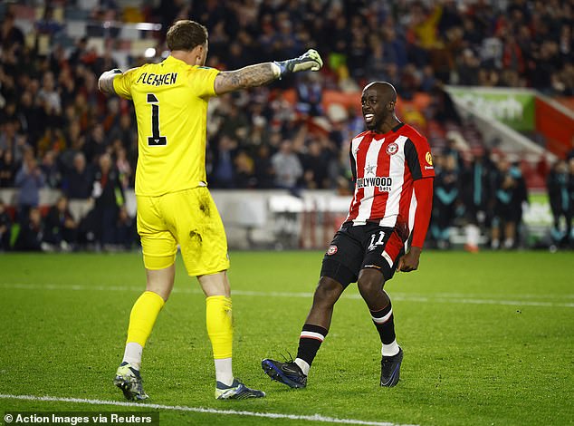 Flekken pictured celebrating with Brentford team-mate Yoane Wissa (right) after the shootout