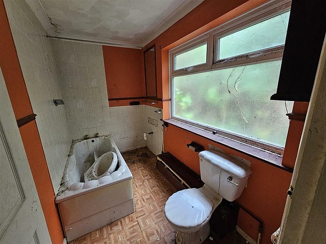 In one of the bathrooms, the sink has been dumped inside the bath