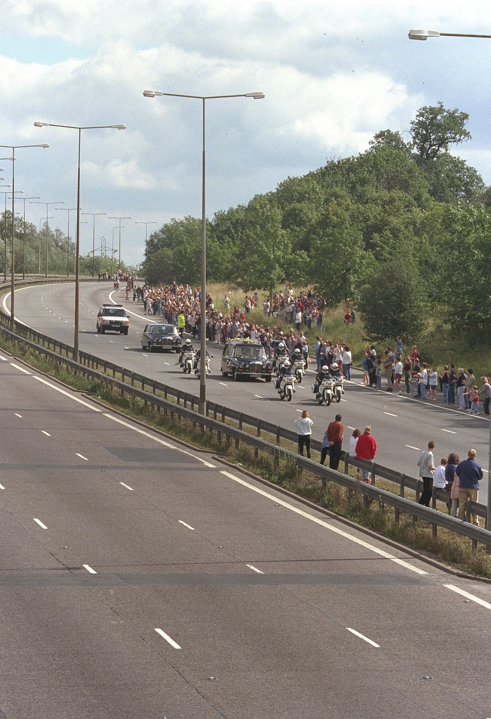 Crowds gathered almost the entire length of the closed stretch of M1 motorway awaiting the funeral cortege of Diana, Princess of Wales, in September 1997