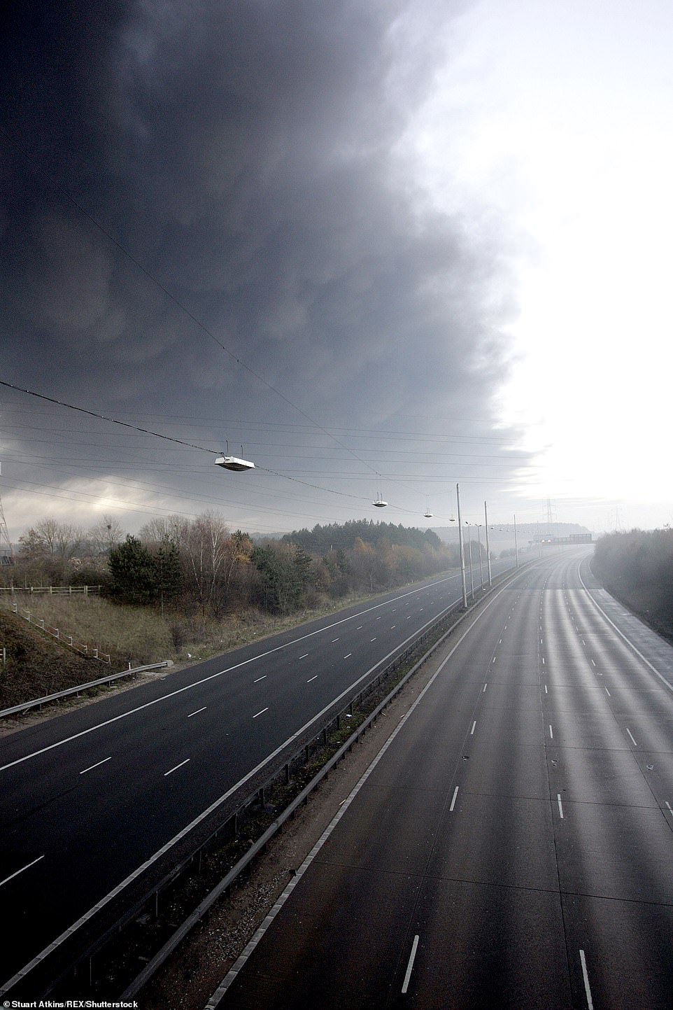 This image shows smoke from the fire following the explosions at Buncefield Fuel Depot over the M1 motorway, which had to be closed