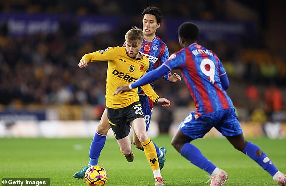 WOLVERHAMPTON, ENGLAND - NOVEMBER 02: Tommy Doyle of Wolverhampton Wanderers battles for possession with Daichi Kamada and Eddie Nketiah of Crystal Palace during the Premier League match between Wolverhampton Wanderers FC and Crystal Palace FC at Molineux on November 02, 2024 in Wolverhampton, England. (Photo by Nathan Stirk/Getty Images)