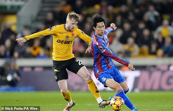 Wolverhampton Wanderers' Tommy Doyle (left) and Crystal Palace's Daichi Kamada (right) battle for the ball during the Premier League match at Molineux, Wolverhampton. Picture date: Saturday November 2, 2024. PA Photo. See PA story SOCCER Wolves. Photo credit should read: Nick Potts/PA Wire.RESTRICTIONS: EDITORIAL USE ONLY No use with unauthorised audio, video, data, fixture lists, club/league logos or "live" services. Online in-match use limited to 120 images, no video emulation. No use in betting, games or single club/league/player publications.