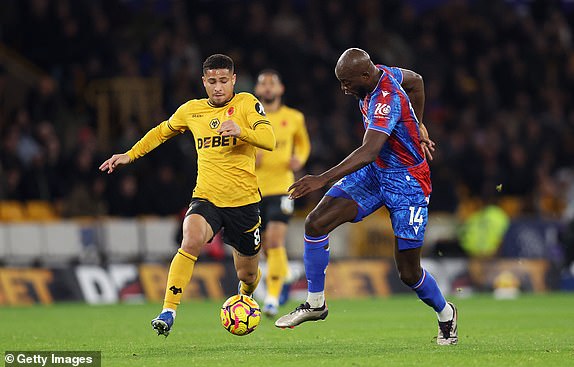 WOLVERHAMPTON, ENGLAND - NOVEMBER 02: Jean-Philippe Mateta of Crystal Palace is challenged by Joao Gomes of Wolverhampton Wanderers during the Premier League match between Wolverhampton Wanderers FC and Crystal Palace FC at Molineux on November 02, 2024 in Wolverhampton, England. (Photo by Nathan Stirk/Getty Images)