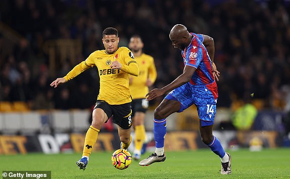 WOLVERHAMPTON, ENGLAND - NOVEMBER 02: Jean-Philippe Mateta of Crystal Palace is challenged by Joao Gomes of Wolverhampton Wanderers during the Premier League match between Wolverhampton Wanderers FC and Crystal Palace FC at Molineux on November 02, 2024 in Wolverhampton, England. (Photo by Nathan Stirk/Getty Images)