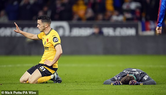 Crystal Palace goalkeeper Dean Henderson reacts after being hit in the face by a shot from Wolverhampton Wanderers' Pablo Sarabia (left) during the Premier League match at Molineux, Wolverhampton. Picture date: Saturday November 2, 2024. PA Photo. See PA story SOCCER Wolves. Photo credit should read: Nick Potts/PA Wire.RESTRICTIONS: EDITORIAL USE ONLY No use with unauthorised audio, video, data, fixture lists, club/league logos or "live" services. Online in-match use limited to 120 images, no video emulation. No use in betting, games or single club/league/player publications.