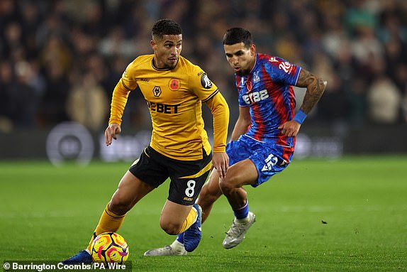 Wolverhampton Wanderers' Joao Gomes and Crystal Palace's Daniel Munoz (right) during the Premier League match at Molineux, Wolverhampton. Picture date: Saturday November 2, 2024. PA Photo. See PA story SOCCER Wolves. Photo credit should read: Barrington Coombs/PA Wire.RESTRICTIONS: EDITORIAL USE ONLY No use with unauthorised audio, video, data, fixture lists, club/league logos or "live" services. Online in-match use limited to 120 images, no video emulation. No use in betting, games or single club/league/player publications.