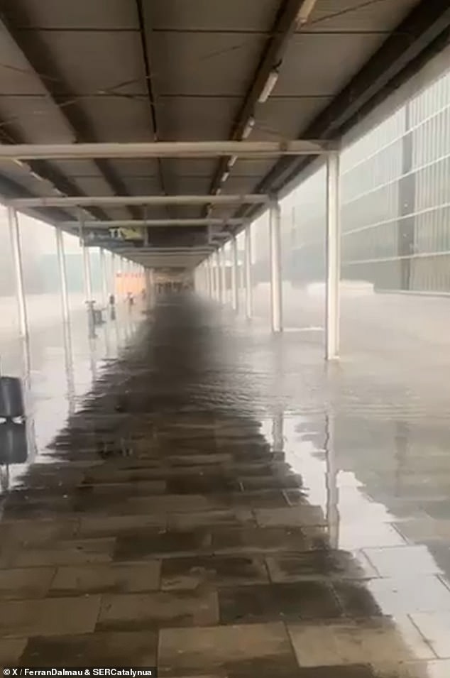 Water covered the walkways outside the airport terminal building as a deluge of rain hit this morning