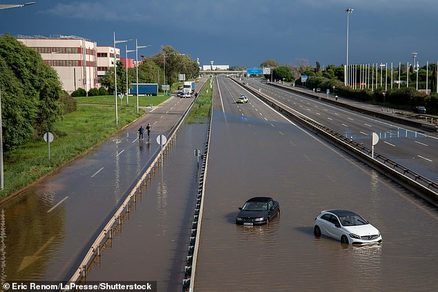 Abandoned cars are seen on a motorway in Catalonia today as heavy rain deluged the Barcelona coastline