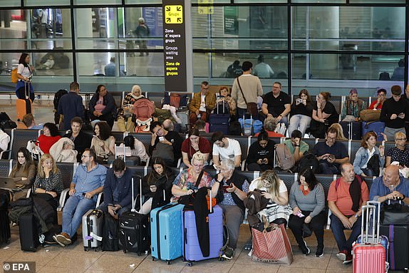 epa11700950 Passengers wait at El Prat Airport after several flights were canceled due to heavy rains, in Barcelona, Catalonia, Spain, 04 November 2024. Spain's airport operator AENA on 04 November said at least 70 flights scheduled to take off from Josep Tarradellas Barcelona-El Prat Airport were cancelled, while 18 others were rerouted, after a heavy rainstorm hit the Barcelona area in the morning. According to Rodalies Catalunya, all local train lines are suspended until the end of civil protection alerts due to the adverse weather conditions.  EPA/TONI ALBIR