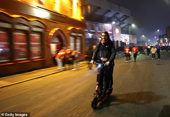 LIVERPOOL, ENGLAND - NOVEMBER 05: A general view outside the stadium as fans ride a scooter prior to the UEFA Champions League 2024/25 League Phase MD4 match between Liverpool FC and Bayer 04 Leverkusen at Anfield on November 05, 2024 in Liverpool, England. (Photo by Carl Recine/Getty Images)