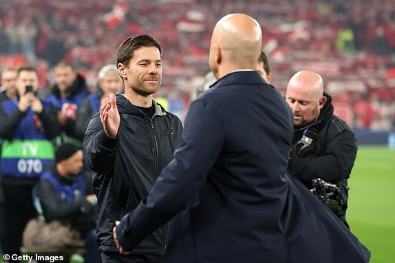 LIVERPOOL, ENGLAND - NOVEMBER 05: Xabi Alonso, Head Coach of Bayer 04 Leverkusen, and Arne Slot, Manager of Liverpool, interact prior to kick-off ahead of the UEFA Champions League 2024/25 League Phase MD4 match between Liverpool FC and Bayer 04 Leverkusen at Anfield on November 05, 2024 in Liverpool, England. (Photo by Carl Recine/Getty Images)