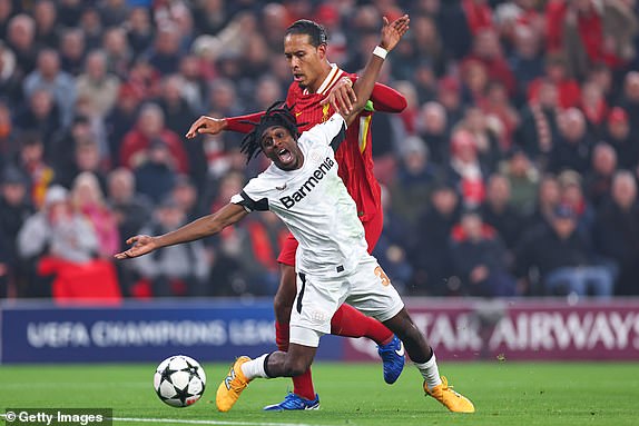 LIVERPOOL, ENGLAND - NOVEMBER 5: Jeremie Frimpong of Bayer Leverkusen reacts after a tackle from Virgil van Dijk of Liverpool during the UEFA Champions League 2024/25 League Phase MD4 match between Liverpool FC and Bayer 04 Leverkusen at Anfield on November 5, 2024 in Liverpool, England. (Photo by Robbie Jay Barratt - AMA/Getty Images)