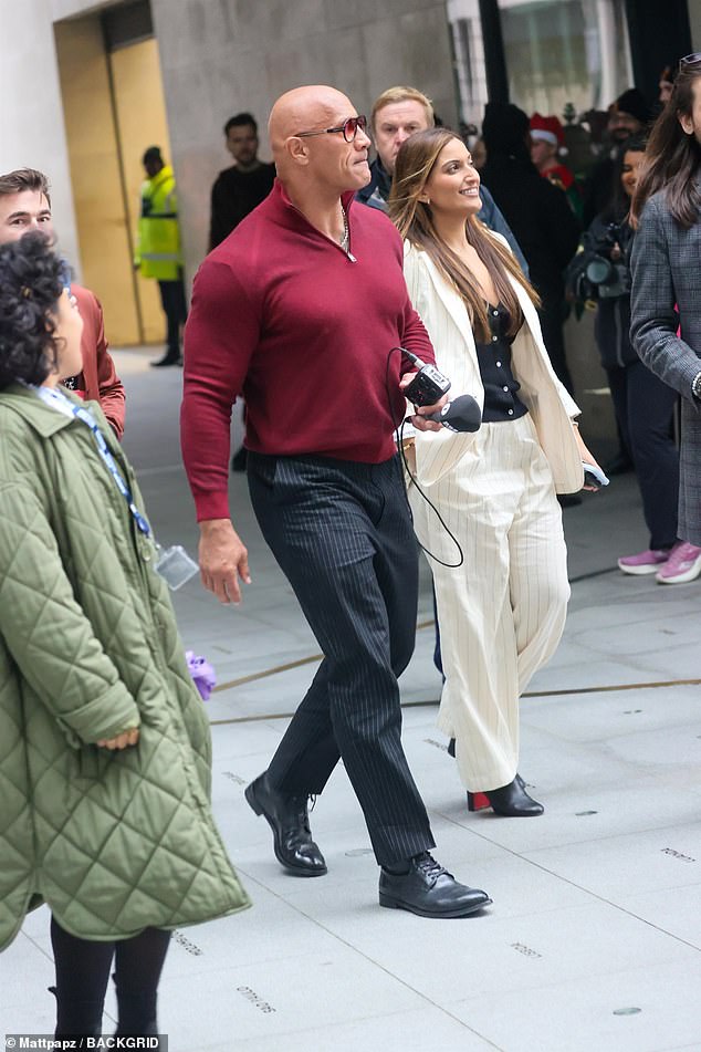 Dwayne looked dapper in a burgundy zip-up jumper which he paired with black pinstripe trousers