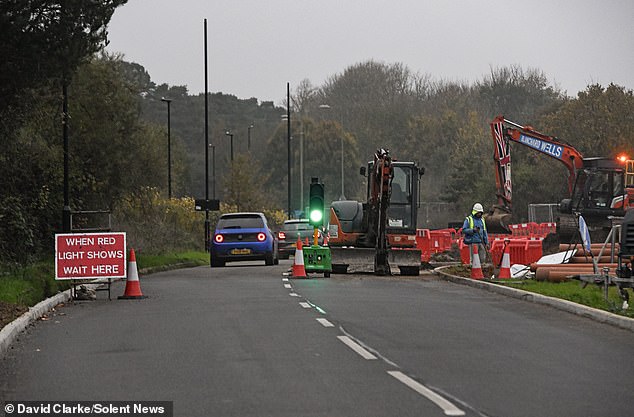 Traffic moves through the temporary traffic lights while construction takes place