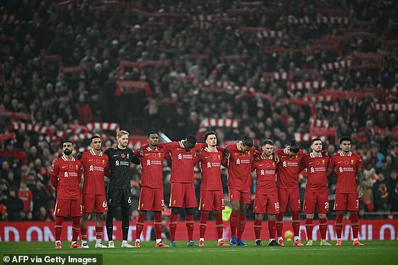 Liverpool players observe a minute of silence to mark Remembrance Day ahead of kick-off in during the English Premier League football match between Liverpool and Aston Villa at Anfield in Liverpool, north west England on November 9, 2024. (Photo by Paul ELLIS / AFP) / RESTRICTED TO EDITORIAL USE. No use with unauthorized audio, video, data, fixture lists, club/league logos or 'live' services. Online in-match use limited to 120 images. An additional 40 images may be used in extra time. No video emulation. Social media in-match use limited to 120 images. An additional 40 images may be used in extra time. No use in betting publications, games or single club/league/player publications. /  (Photo by PAUL ELLIS/AFP via Getty Images)