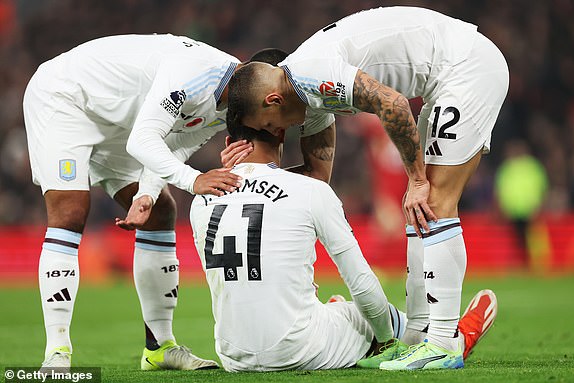 LIVERPOOL, ENGLAND - NOVEMBER 09: Jacob Ramsey of Aston Villa reacts with an injury as Lucas Digne of Aston Villa comforts him during the Premier League match between Liverpool FC and Aston Villa FC at Anfield on November 09, 2024 in Liverpool, England. (Photo by Carl Recine/Getty Images)