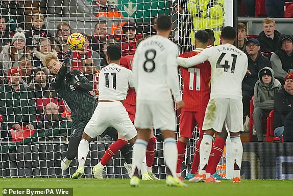 Liverpool goalkeeper Caoimhin Kelleher (left) makes a save during the Premier League match at Anfield, Liverpool. Picture date: Saturday November 9, 2024. PA Photo. See PA story SOCCER Liverpool. Photo credit should read: Peter Byrne/PA Wire.RESTRICTIONS: EDITORIAL USE ONLY No use with unauthorised audio, video, data, fixture lists, club/league logos or "live" services. Online in-match use limited to 120 images, no video emulation. No use in betting, games or single club/league/player publications.