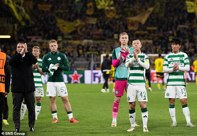 Grim-faced Celtic stars applaud the travelling support after their hammering in Dortmund