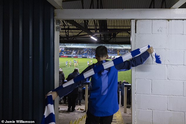 A young fan savours the perfect vantage point for the Championship match