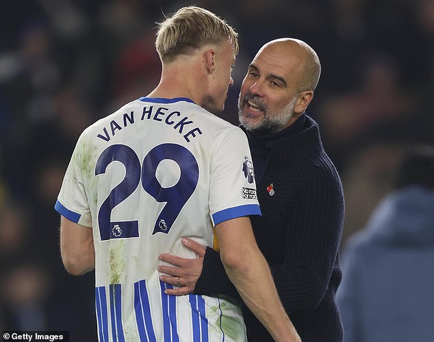 Guardiola pictured with his left arm around the waist of Van Hecke during their discussion