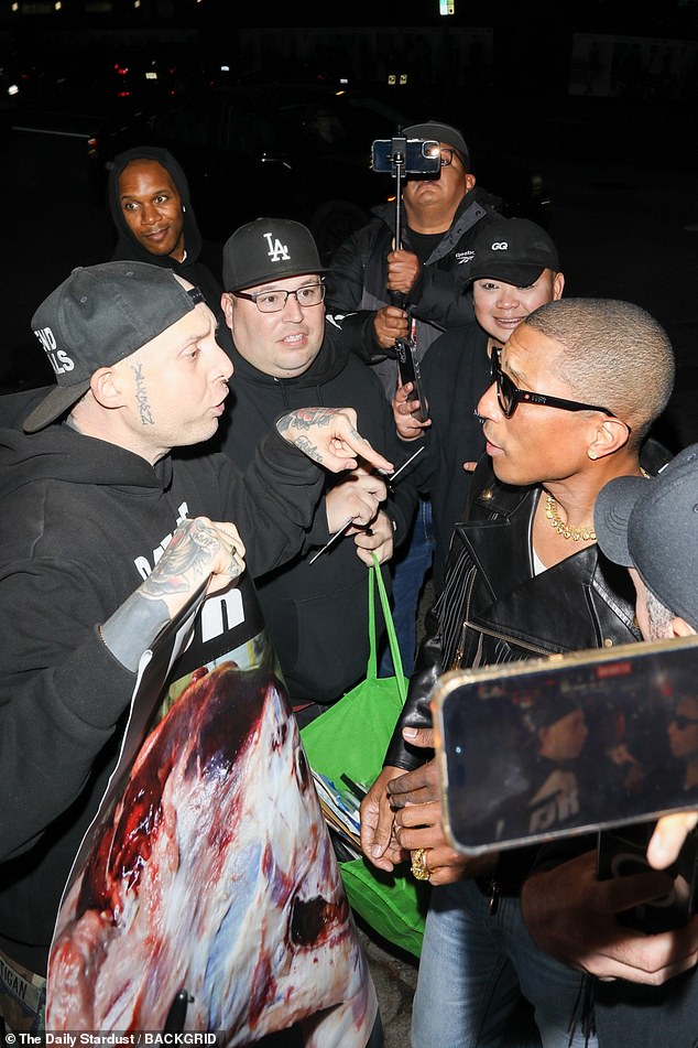 Pharrell attempted to hug an animal rights activist who confronted him outside of the Chateau Marmont following the GQ Men of the Year Awards