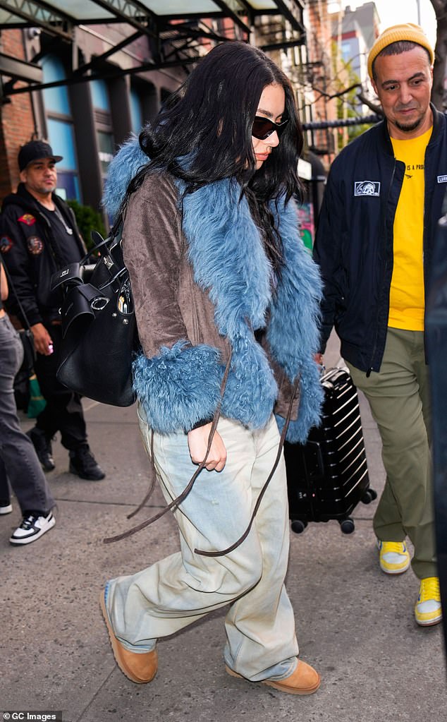 The Brat hitmaker also sported a pair of tan boots along with a light blue top as she enjoyed her trip to the Big Apple