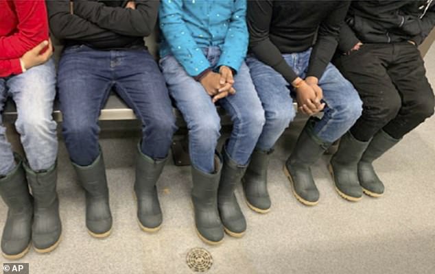 A photo of the survivors show how the Indian nationals were inadequately dressed for the blizzard