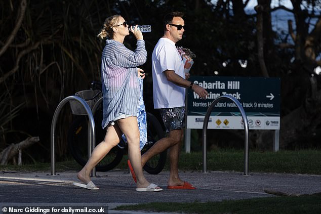 The couple sported sliders and shades as they enjoyed the casual stroll together