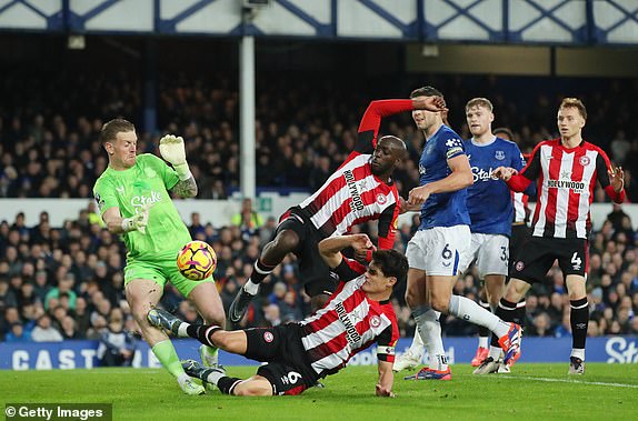 LIVERPOOL, ENGLAND - NOVEMBER 23: Jordan Pickford of Everton is fouled by Christian Norgaard of Brentford leading to a red card decision during the Premier League match between Everton FC and Brentford FC at Goodison Park on November 23, 2024 in Liverpool, England. (Photo by Jan Kruger/Getty Images)