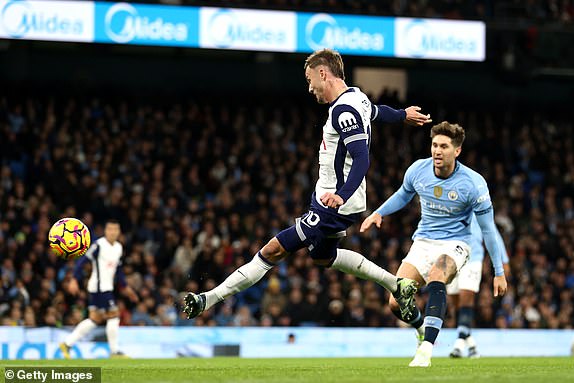 MANCHESTER, ENGLAND - NOVEMBER 23: James Maddison of Tottenham Hotspur scores his team's first goal during the Premier League match between Manchester City FC and Tottenham Hotspur FC at Etihad Stadium on November 23, 2024 in Manchester, England. (Photo by Naomi Baker/Getty Images)