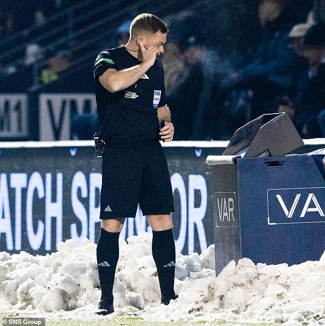 John Beaton wades through the snow to check the St Mirren VAR system on Saturday