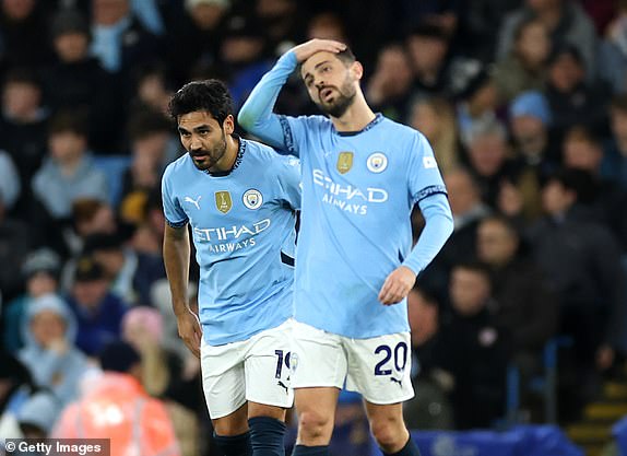 MANCHESTER, ENGLAND - NOVEMBER 23: Ilkay Guendogan and Bernardo Silva of Manchester City look dejected after James Maddison of Tottenham Hotspur (not pictured) scores his team's first goal during the Premier League match between Manchester City FC and Tottenham Hotspur FC at Etihad Stadium on November 23, 2024 in Manchester, England. (Photo by Carl Recine/Getty Images)