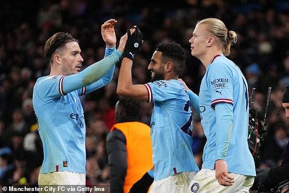 MANCHESTER, ENGLAND - JANUARY 19: Riyad Mahrez of Manchester City celebrates with teammates Jack Grealish and Erling Haaland after scoring the team's fourth goal  during the Premier League match between Manchester City and Tottenham Hotspur at Etihad Stadium on January 19, 2023 in Manchester, England. (Photo by Matt McNulty - Manchester City/Manchester City FC via Getty Images)